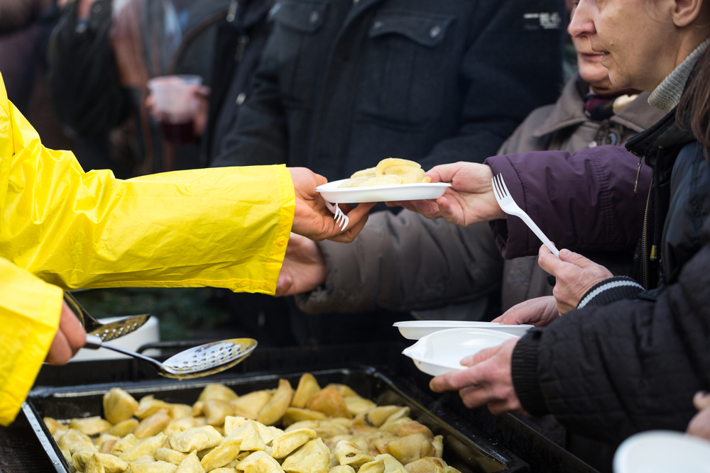 CRACOW, POLAND - DECEMBER 20, 2015: Christmas Eve for poor and homeless on the Central Market in Cracow. Every year the group Kosciuszko prepares the greatest eve in the open air in Poland