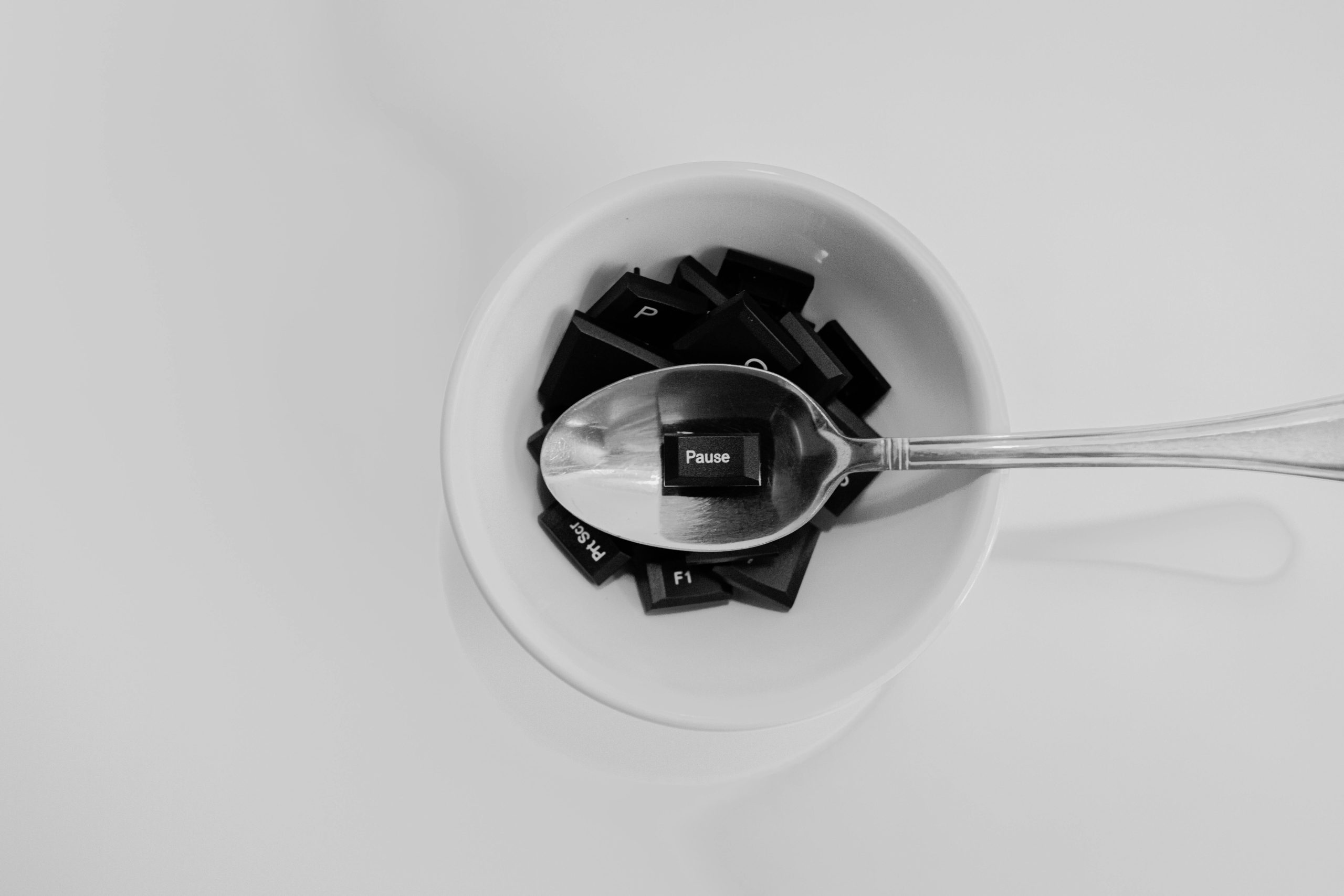 a coffee cup with tiles inside and a spoon hovering above it with a tile that says Pause