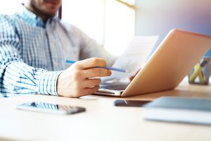 person working at a desk with laptop